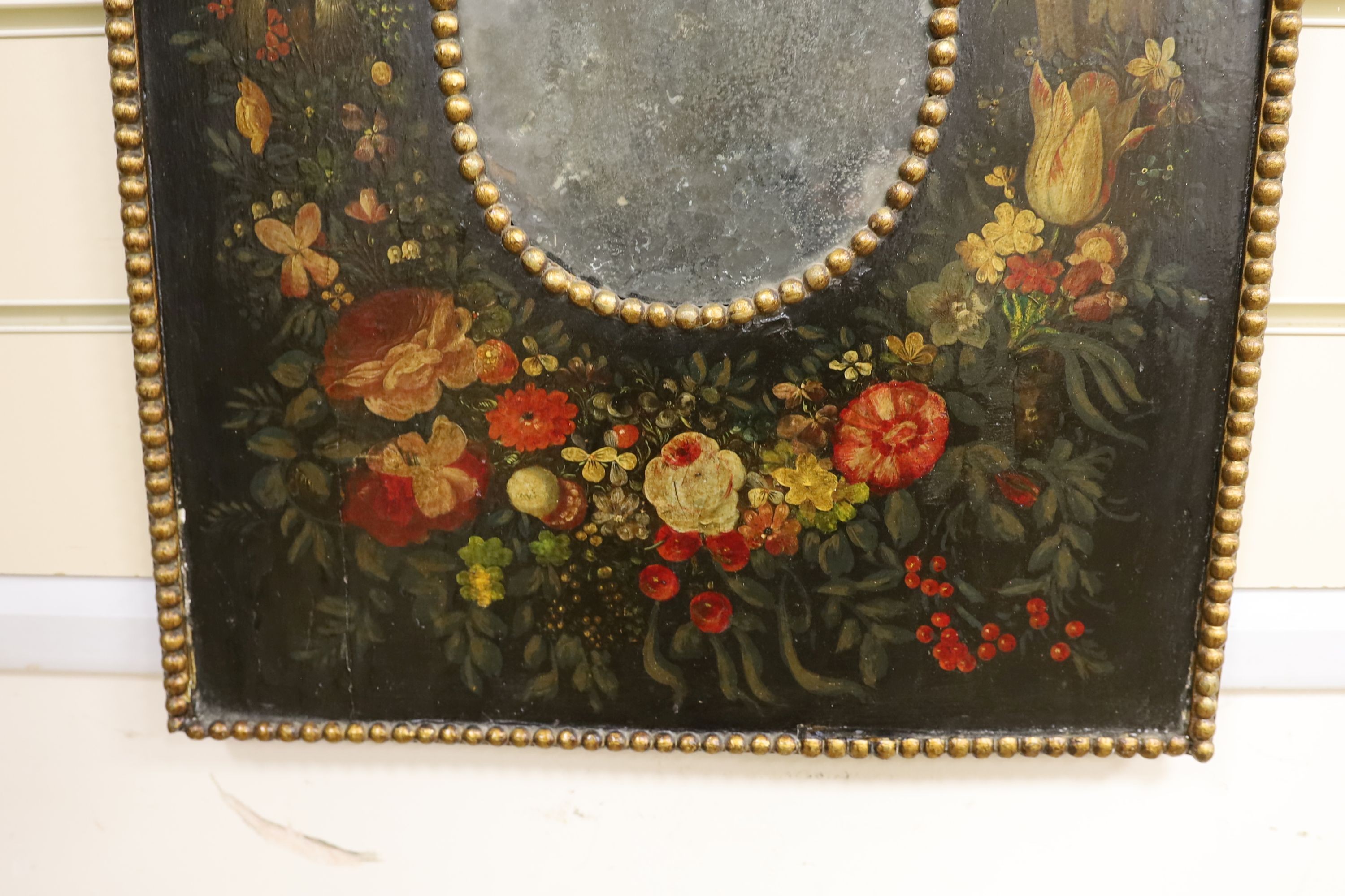A small 18th century and later rectangular Dutch painted wall mirror